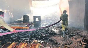 firemen try to douse the fire in Ludhiana on Thursday. 