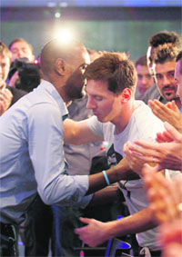 Eric Abidal embraces teammate Lionel Messi after the press conference on Thursday.
