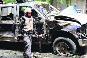 A policeman at the site of a car bomb blast in Baghdad on Thursday