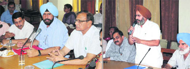(Left) Mayor Baljit Singh Birbehman flanked by municipal commissioner Uma Shankar Gupta and Senior Deputy Mayor Tarsem Goyal during the general House meeting of the Municipal Corporation, Bathinda, on Friday; and (Right) municipal councillor Jagroop Singh Gill voicing his concern during the meeting.