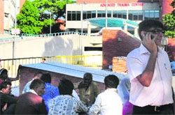 A man uses his mobile phone on the PGI complex. a tribune photograph