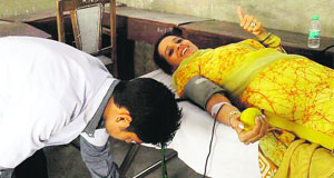 A woman donates blood at a camp in Mussoorie on Friday.