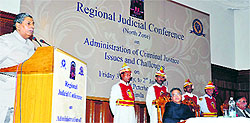 Mr Justice BS Chauhan speaks at a regional judicial conference as Justice AM Khanwilkar looks on in Shimla on Friday