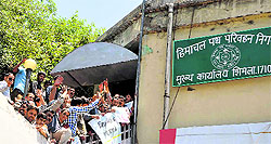Activists of the Shimla Nagrik Sabha demonstrate at the office of the Himachal Road Transport Corporation Managing Director demanding night bus service at the old bus stand in Shimla on Friday