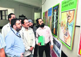Artist Suresh Sharma (extreme right) displays his poster exhibition on the occasion of World No-Tabacoo Day at Government Hospital, Sarwal, in Jammu