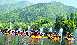 Boatmen arrange their traditional shikaras in a row at the Dal Lake in Srinagar on Friday