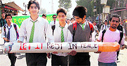School students hold an anti-tobacco placard during a rally to mark World No Tobacco Day in Srinagar on Friday