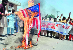 Demonstrators torch a US flag in Multan on Friday.  AFP