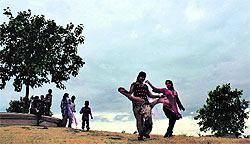 With clouds hovering over the Doon Valley, children enjoy the pleasant weather in Dehradun on Saturday