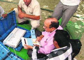 Polling officials get EVMs for their polling booths in Hisar on Saturday