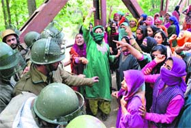 Residents clash with security personnel during an encounter with militants at Wandana village in Shopian on Saturday