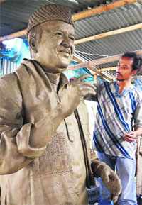 A student of Government College of Arts and Crafts works on a nine-ft tall statue of music legend Bhupen Hazarika in Guwahati on Saturday.