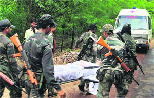 Security personnel carry a body at the site of Maoists ambush in Bastar where the top Congress leadership of the state was attacked. PTI file Photo 