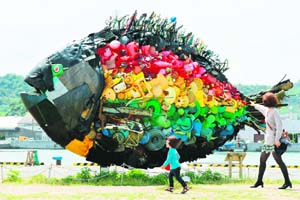 A large sea bream object, made from colourful debris found drifting at sea, such as plastic tanks, toys and wires, and produced by Japanese art group Yodogawa Tecnique, is displayed at the Setouchi Triennale art event at the port of Uno, Okayama prefecture in western Japan