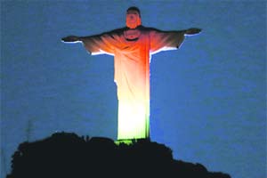 The statue of Christ the Redeemer is seen lit up in the colours of Germany's national flag during an event celebrating the opening of the Germany + Brazil 2013-2014 season in Rio de Janeiro