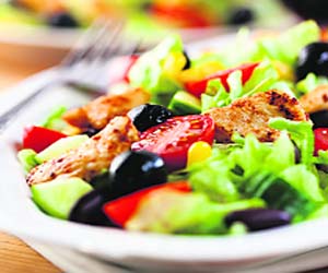 Chicken salad is made from iceberg lettuce and pieces of sliced, grilled or tandoori chicken