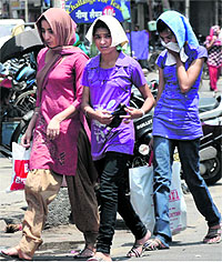 eople venture out of their homes with their heads covered as temperature has once again started heading north in Bathinda