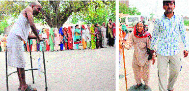 A patient walks to a polling booth at Kambopura village of Karnal on Sunday even as a long queue of voters (in the background) awaits its turn to cast votes; and (right) an old woman is escorted to a booth in Rohtak. Tribune photos: Ravi Kumar, Manoj Dhaka
