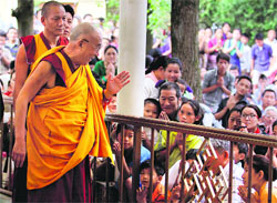 Tibetan spiritual leader Dalai Lama greets followers before the religious teaching on Shantideva's "A Guide to the Boddhisattva's Way of Life (chodjug)" at Mcleodganj on Sunday. Photo: Kamaljeet