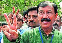 Trinamool Congress candidate Prasun Banerjee poses with supporters at a polling station during the bypoll to the Howrah Lok Sabha seat on Sunday