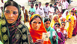 Voters stand in a long queue to cast their votes for the Maharajganj Lok Sabha seat in Chhapra, Bihar, on Sunday
