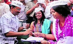 Aam Aadmi Party leader Arvind Kejriwal gets signatures of people to contest coming Assembly elections, in New Delhi on Sunday