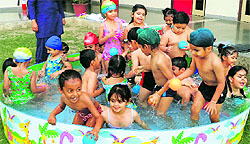 Children try to beat the heat during a splash pool party at Millennium School in Patiala on Sunday