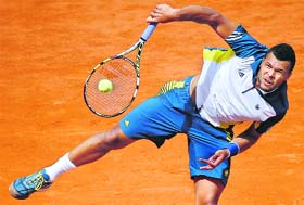 Jo-Wilfried Tsonga hits a return to Serbias Viktor Troicki during a French tennis Open round of 16 match at the Roland Garros stadium in Paris on Sunday