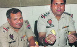 Railway police officials show the gold jewellery seized from two Rajasthan traders at the railway station in Amritsar on Monday: 
