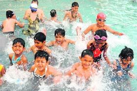 Summer splash: Children enjoy swimming in a pool in Bathinda on Monday