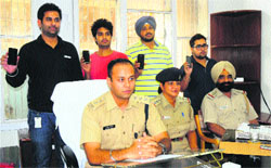 Rajesh Kalia, DSP (cyber cell), and owners with recovered mobile phones in Chandigarh on Monday. Tribune photo: S Chandan 