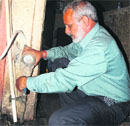 An MC employee disconnects the water supply of a defaulter at the Booth Market in Sector 21, Chandigarh. A file photo