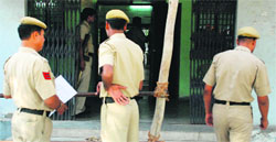 Policemen deployed at the entrance gate of a hall where EVMs have been kept at the BHEL Officers' Colony in Sector 14, Panchkula, on Monday. Tribune photo: Nitin Mittal