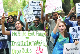 Students shouting slogans during the protest march against the Four Year Undergraduate Programme which is set to be implemented from this academic session, on North Campus on Monday.