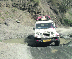 Pilgrims risk their lives on a dilapidated road on the Yamnotri route, near Barkot.