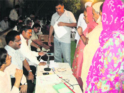 DC Pankaj Aggarwal listens to public grievances in a night camp at Mandori village, Sonepat. Photo by writer