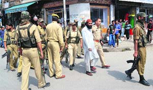 Policemen keep a vigil in Anantnag on Monday. 