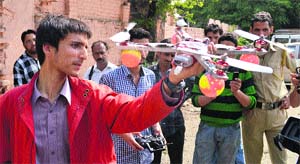 A group of college students display a flying machine made by them, in Srinagar on Monday. 