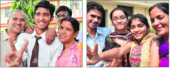 Sarika ( 96.15%, third position) and Deepak Kumar (joint third) flash the victory sign with their relatives in Ludhiana on Monday. 