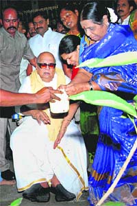DMK president M Karunanidhi plants a sapling on his 90th birthday at his CIT Colony residence in Chennai on Monday