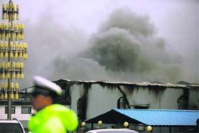 Smoke rises from the poultry plant at Dehui city in northeast China on Monday