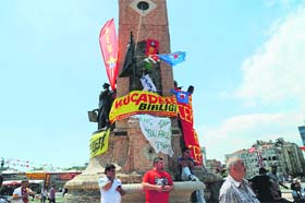 Protestors stand around the Republic monument on Taksim square in Istanbul on Monday