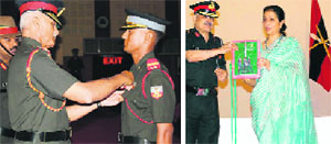 Lt-Gen Manvendra Singh, Commandant, IMA, pins an award on a passing-out Gentleman Cadet in Dehradun on Tuesday; and (right) Lina Mathews, wife of Maj-Gen Bobby Mathews, VSM, Deputy Commandant and Chief Instructor, IMA, releases the IMA journal, Spring Term-2013.