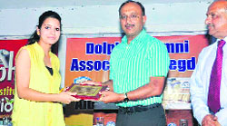 Arvind Gupta, Chairman of Dolphin Institute, presents a memento to an alumna at a function held to mark World Environment Day in Dehradun on Tuedsay.