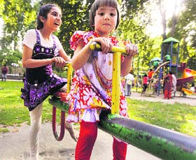 Children enjoy a see-saw at a park in Srinagar on Tuesday. 