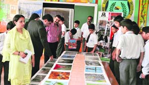 Visitors at the exhibition in Kashmir Harvard School in Srinagar on Tuesday.