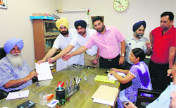 Parents of students studying at Ryan School, Dugri, submit a memorandum to Assistant Commissioner (Grievances) JP Singh on Tuesday. Photo: Inderjeet Verma