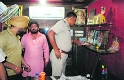Police personnel at the office where the firing incident took place in Ludhiana on Tuesday. a Tribune photograph