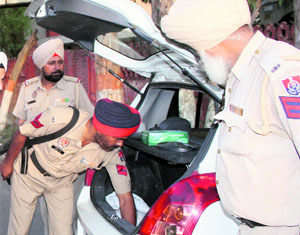 On the eve of the 29th anniversary of the Operation Bluestar, the Punjab Police tightened security in various parts of Amritsar. A police team checks a vehicle at the Lawrence Road chowk. 