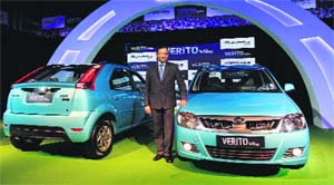 Pawan Goenka, president of automotive & farm equipment sectors at Mahindra & Mahindra, poses with the firms newly unveiled Verito Vibe compact car in Mumbai on Wednesday. 